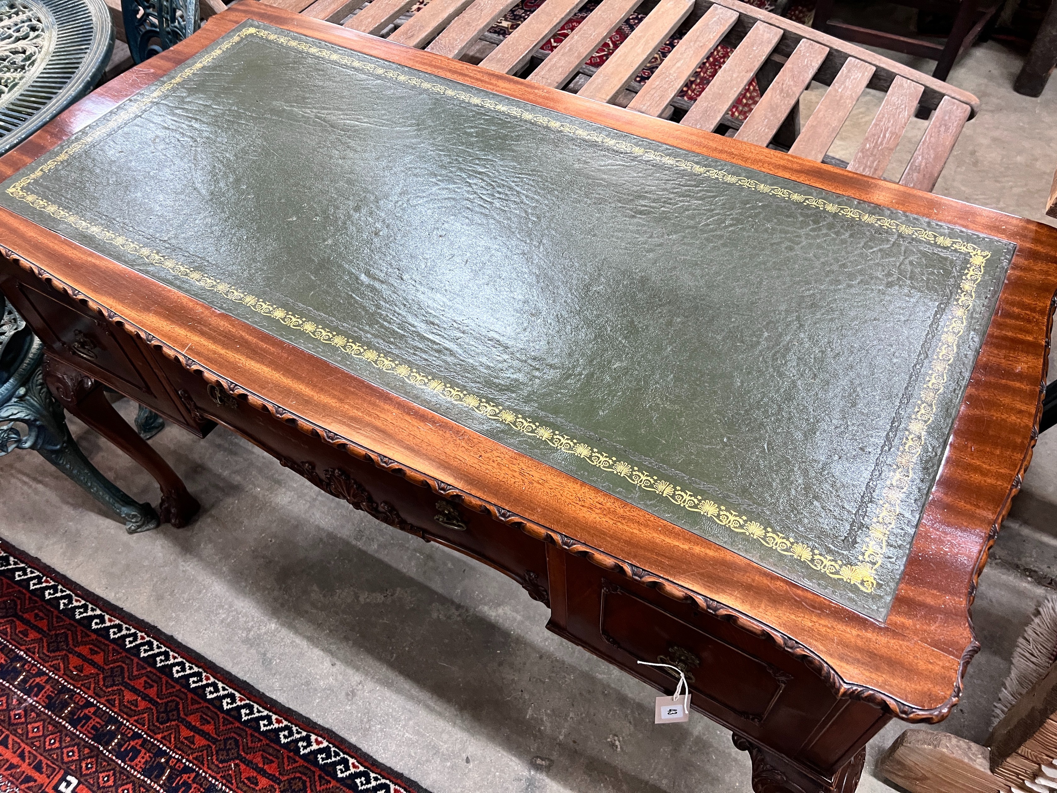 A reproduction George III style mahogany kneehole writing table, width 120cm, depth 58cm, height 76cm *Please note the sale commences at 9am.